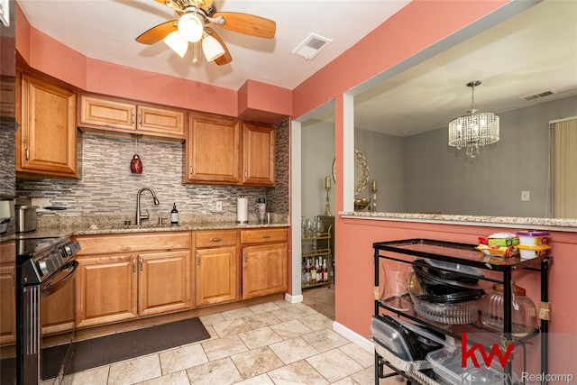 24327 Evergreen Rd, Southfield, MI 48075 - kitchen with black range oven, a sink, decorative backsplash, and light stone countertops