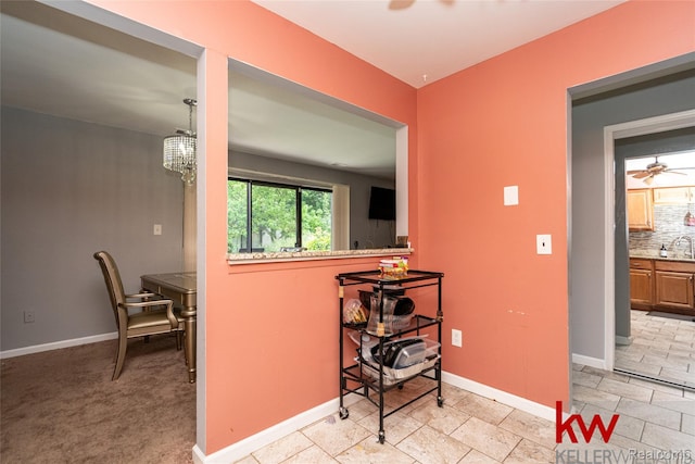 24327 Evergreen Rd, Southfield, MI 48075 - corridor with baseboards and a chandelier