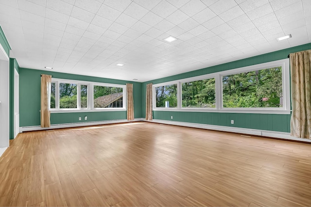 7938 E Dr N, Battle Creek, MI 49014 - unfurnished room featuring wood finished floors, a baseboard radiator, and baseboards