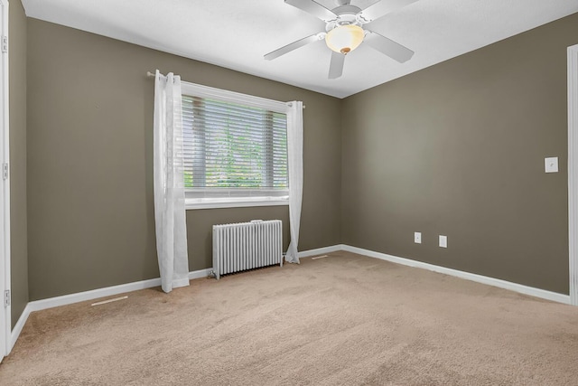 7938 E Dr N, Battle Creek, MI 49014 - carpeted empty room with radiator heating unit, baseboards, and a ceiling fan