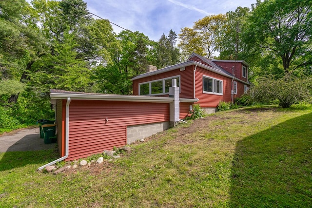 7938 E Dr N, Battle Creek, MI 49014 - view of side of home featuring a chimney and a lawn