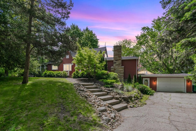 7938 E Dr N, Battle Creek, MI 49014 - view of front of home featuring asphalt driveway, an attached garage, and a lawn