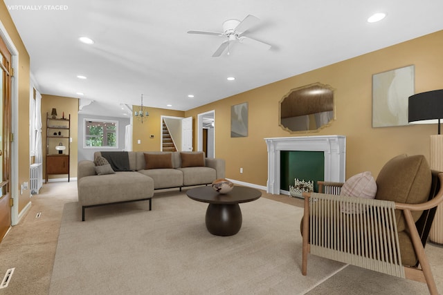 7938 E Dr N, Battle Creek, MI 49014 - living room featuring light carpet, a fireplace, ceiling fan, recessed lighting, and stairs
