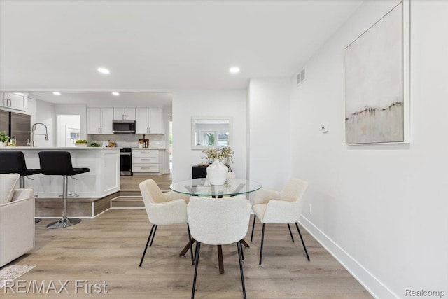31111 Angeline Ct E, Saint Clair Shores, MI 48082 - dining space with recessed lighting, light wood-style flooring, and baseboards