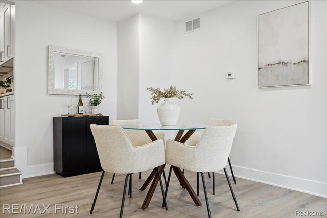31111 Angeline Ct E, Saint Clair Shores, MI 48082 - dining space featuring light wood-style floors, baseboards, and stairway