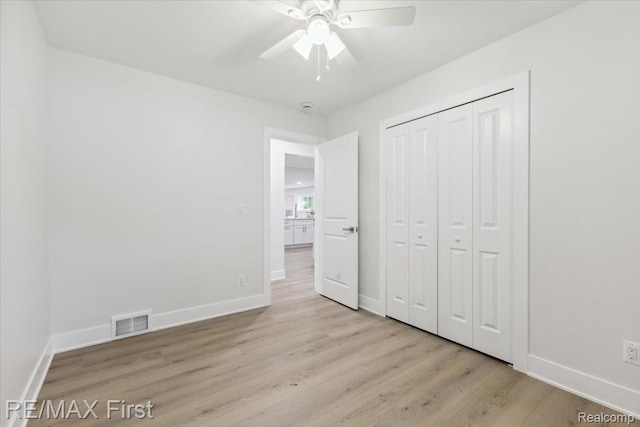 31111 Angeline Ct E, Saint Clair Shores, MI 48082 - unfurnished bedroom with light wood-type flooring, baseboards, a closet, and ceiling fan