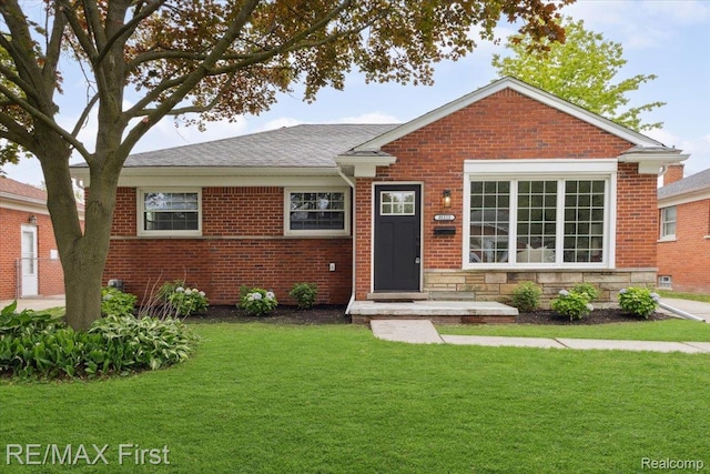 31111 Angeline Ct E, Saint Clair Shores, MI 48082 - view of front facade with a front yard, brick siding, and a shingled roof