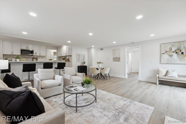 31111 Angeline Ct E, Saint Clair Shores, MI 48082 - living room featuring light wood-style floors, recessed lighting, and baseboards