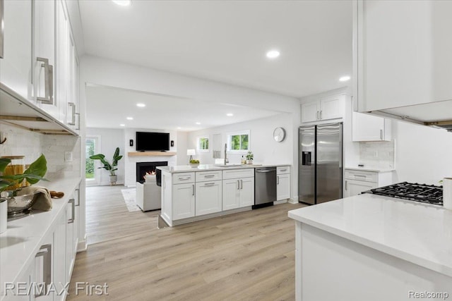 31111 Angeline Ct E, Saint Clair Shores, MI 48082 - kitchen featuring stainless steel appliances, healthy amount of natural light, a sink, white cabinets, and recessed lighting