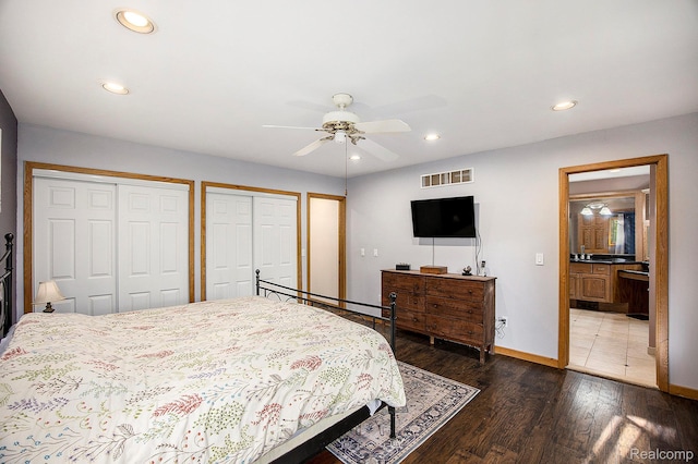 1295 Kern Rd, Oakland, MI 48363 - bedroom with two closets, wood finished floors, recessed lighting, baseboards, and ensuite bathroom