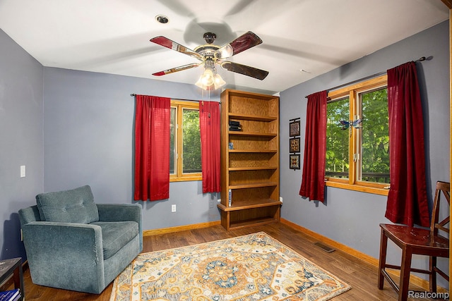 1295 Kern Rd, Oakland, MI 48363 - sitting room featuring wood finished floors, plenty of natural light, a ceiling fan, and baseboards