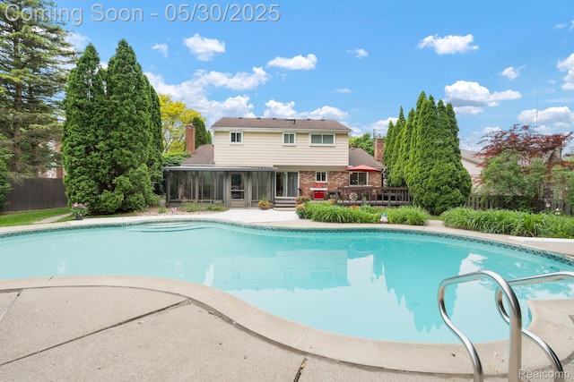 9495 Continental Dr, Taylor, MI 48180 - outdoor pool featuring a wooden deck and a sunroom