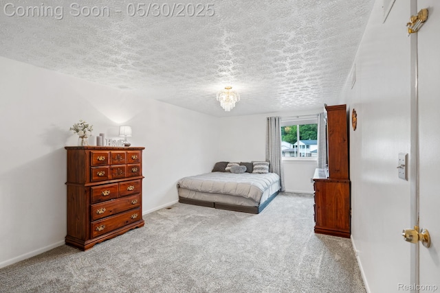 9495 Continental Dr, Taylor, MI 48180 - bedroom featuring a textured ceiling, carpet floors, baseboards, and a chandelier