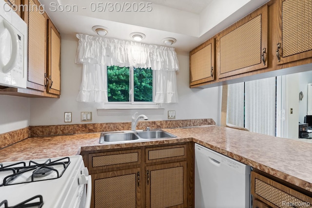 9495 Continental Dr, Taylor, MI 48180 - kitchen with white appliances, a sink, brown cabinets, and light countertops