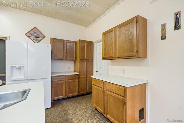 9495 Continental Dr, Taylor, MI 48180 - kitchen with white refrigerator with ice dispenser, light countertops, brown cabinets, and a sink