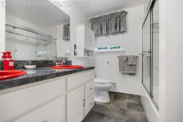 9495 Continental Dr, Taylor, MI 48180 - bathroom featuring vanity, toilet, baseboards, and shower / bath combination with glass door