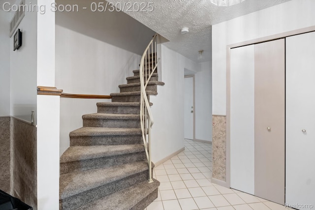 9495 Continental Dr, Taylor, MI 48180 - stairs featuring tile patterned flooring and a textured ceiling