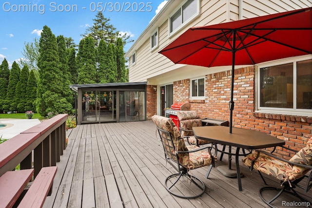 9495 Continental Dr, Taylor, MI 48180 - wooden terrace with outdoor dining area and a sunroom