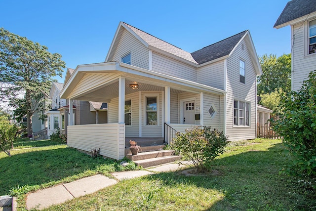 224 Spencer St NE, Grand Rapids, MI 49505 - view of front of house featuring a porch, a front lawn, and a shingled roof