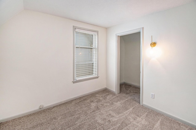 224 Spencer St NE, Grand Rapids, MI 49505 - unfurnished bedroom featuring carpet flooring, baseboards, and lofted ceiling