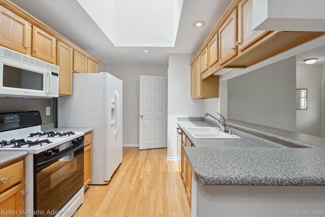 48727 Aberdeen Ct, Shelby Twp, MI 48315 - kitchen featuring white appliances, a skylight, a sink, recessed lighting, and light wood finished floors