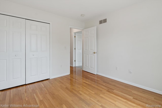 48727 Aberdeen Ct, Shelby Twp, MI 48315 - unfurnished bedroom featuring light wood finished floors, baseboards, and a closet