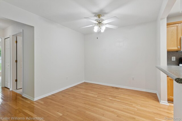 48727 Aberdeen Ct, Shelby Twp, MI 48315 - unfurnished dining area featuring light wood finished floors, baseboards, and ceiling fan