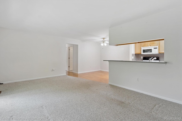 48727 Aberdeen Ct, Shelby Twp, MI 48315 - unfurnished living room with light colored carpet, ceiling fan, and baseboards