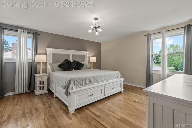 1916 Squirrel Valley Dr, Bloomfield Hills, MI 48304 - bedroom featuring multiple windows, light wood-style flooring, a chandelier, and baseboards