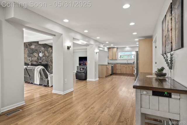 1916 Squirrel Valley Dr, Bloomfield Hills, MI 48304 - kitchen with dark countertops, light wood-style flooring, freestanding refrigerator, a sink, and recessed lighting