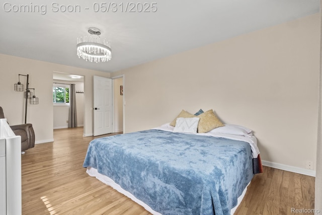 1916 Squirrel Valley Dr, Bloomfield Hills, MI 48304 - bedroom with light wood-style floors, baseboards, and a chandelier