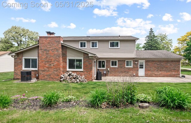 1916 Squirrel Valley Dr, Bloomfield Hills, MI 48304 - back of house featuring a patio area, a yard, cooling unit, and brick siding