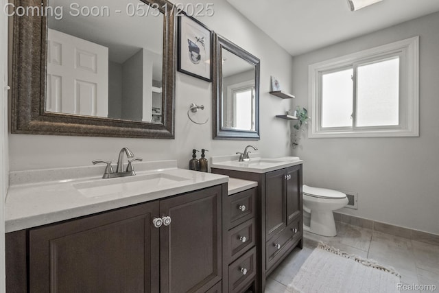 1916 Squirrel Valley Dr, Bloomfield Hills, MI 48304 - full bathroom featuring two vanities, toilet, and baseboards