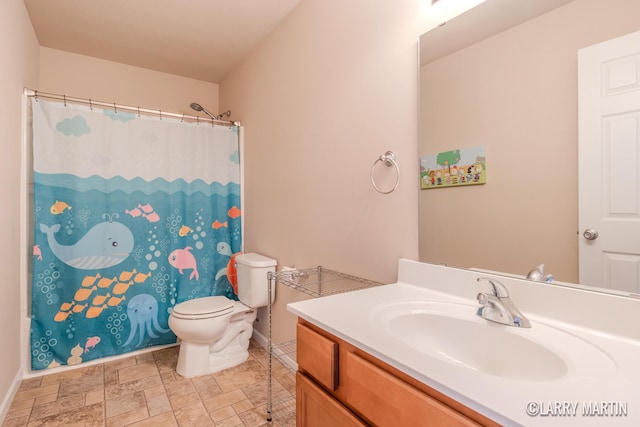 709 Wild Flower Dr, Wayland, MI 49348 - bathroom with vanity, toilet, baseboards, stone finish flooring, and curtained shower