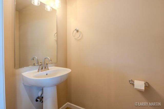 709 Wild Flower Dr, Wayland, MI 49348 - bathroom featuring baseboards and a sink