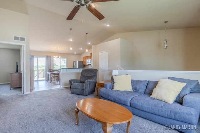709 Wild Flower Dr, Wayland, MI 49348 - living room featuring a ceiling fan, light carpet, vaulted ceiling, baseboards, and a chandelier