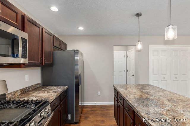 4335 Norway St, Holt, MI 48842 - kitchen with stainless steel appliances, dark wood-style floors, baseboards, pendant lighting, and dark brown cabinetry