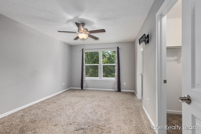 4335 Norway St, Holt, MI 48842 - unfurnished bedroom featuring carpet flooring, a textured ceiling, baseboards, and a ceiling fan