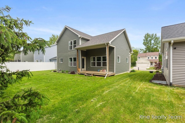 4335 Norway St, Holt, MI 48842 - rear view of house with a wooden deck and roof with shingles