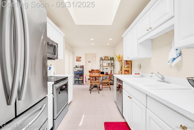 48757 Tilford Ct, Shelby Twp, MI 48315 - kitchen with appliances with stainless steel finishes, a sink, white cabinets, light countertops, and recessed lighting