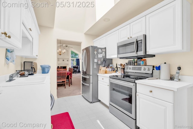 48757 Tilford Ct, Shelby Twp, MI 48315 - kitchen featuring appliances with stainless steel finishes, a chandelier, a sink, white cabinetry, and light countertops