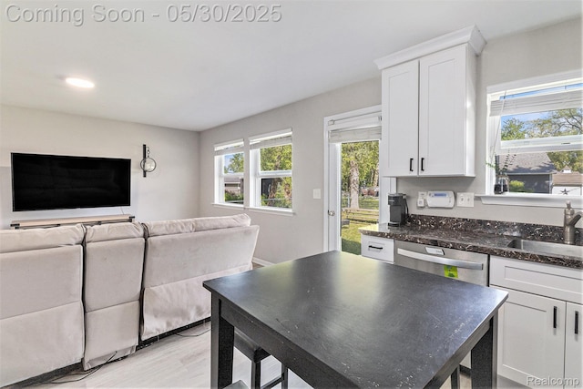 9475 Beechcrest Dr, White Lake, MI 48386 - kitchen with a sink, open floor plan, white cabinetry, dishwasher, and light wood-style flooring
