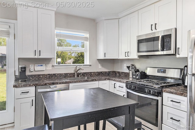 9475 Beechcrest Dr, White Lake, MI 48386 - kitchen with appliances with stainless steel finishes, a sink, healthy amount of natural light, and white cabinetry