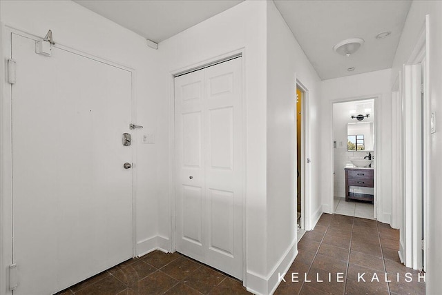 505 Cherry St SE Unit 612, Grand Rapids, MI 49503 - hall with baseboards and dark tile patterned flooring