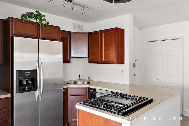 505 Cherry St SE Unit 612, Grand Rapids, MI 49503 - kitchen featuring stainless steel refrigerator with ice dispenser, cooktop, a sink, light countertops, and a peninsula