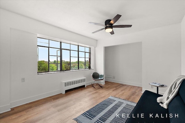 505 Cherry St SE Unit 612, Grand Rapids, MI 49503 - sitting room with radiator, ceiling fan, wood finished floors, and baseboards