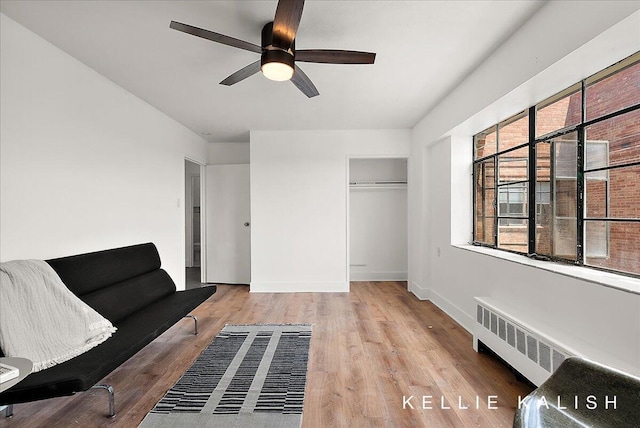 505 Cherry St SE Unit 612, Grand Rapids, MI 49503 - living area with radiator heating unit, a ceiling fan, wood finished floors, and baseboards