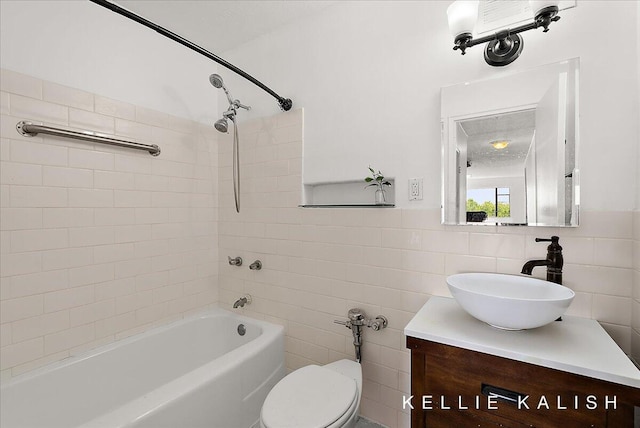 505 Cherry St SE Unit 612, Grand Rapids, MI 49503 - bathroom with tile walls, vanity, shower / bath combination, and toilet