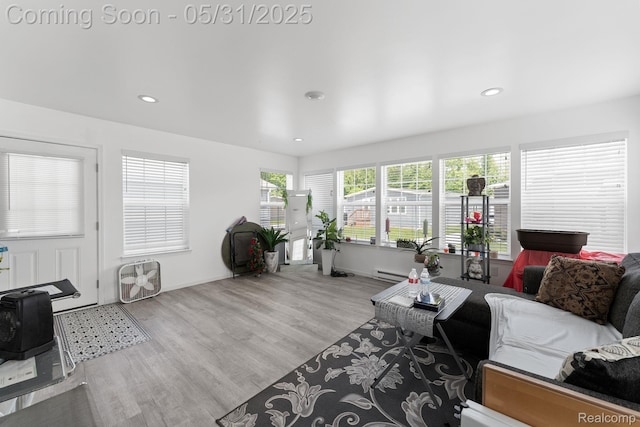 8551 Boyer Dr, Willis, MI 48191 - living room featuring wood finished floors, recessed lighting, baseboard heating, and baseboards