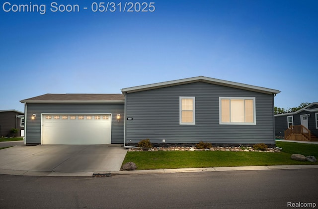 8551 Boyer Dr, Willis, MI 48191 - view of front of home with driveway, an attached garage, and a front lawn
